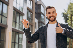 Young man with keys selling his apartment